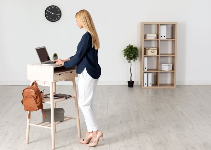 mulher loira utilizando stand up desk